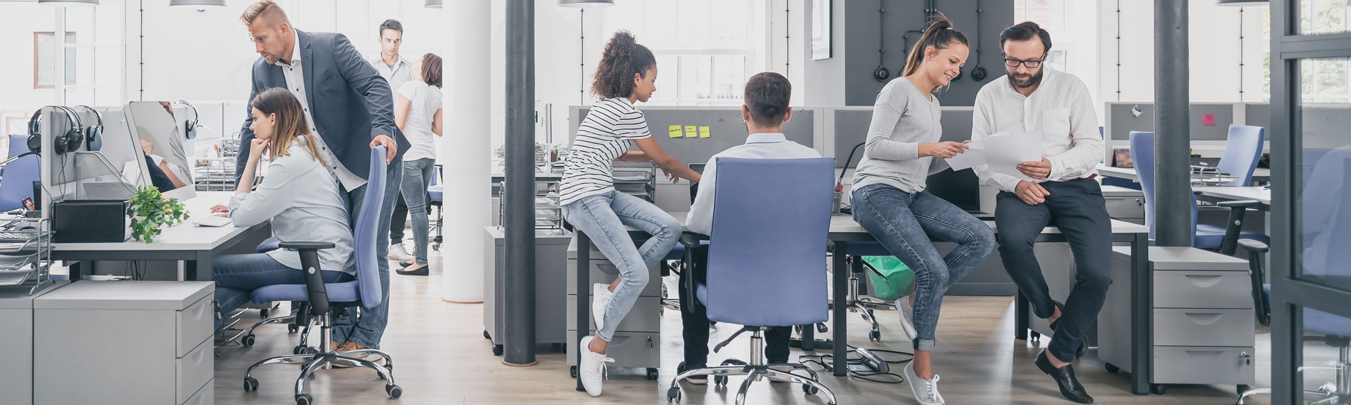 Open office space with multiple people interacting with each other Open office space with multiple people interacting with each other